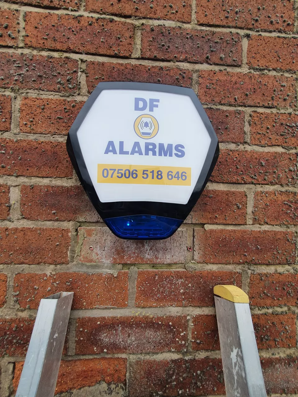 A DF Alarms bell box on a brick wall